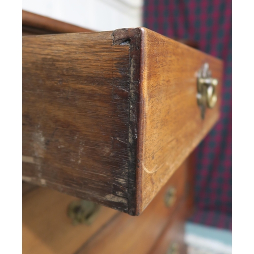 12 - A Georgian mahogany two-over-three chest of drawers, on bracket feet, with pull-out writing surface ... 