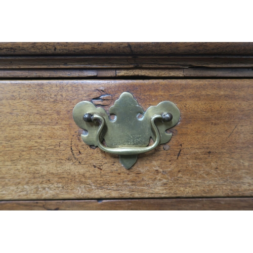 12 - A Georgian mahogany two-over-three chest of drawers, on bracket feet, with pull-out writing surface ... 