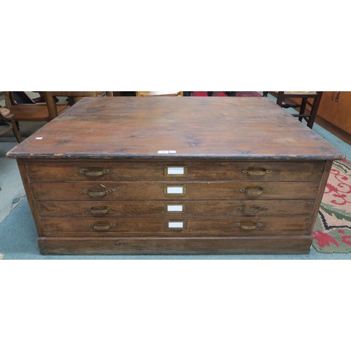 129 - An early 20th century oak and pine four drawer plan chest, 53cm high x 124cm wide x 91cm deep