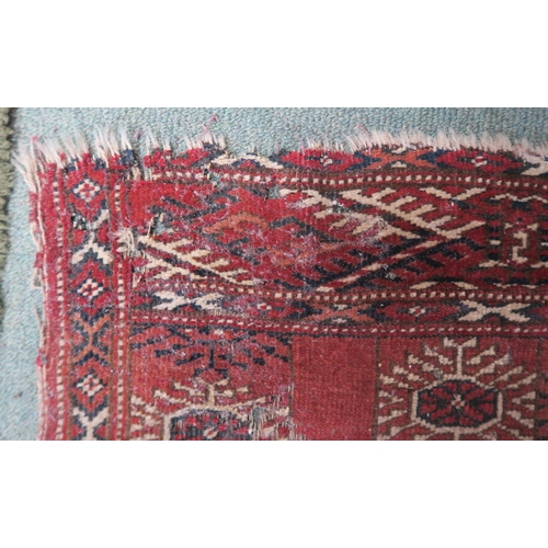 63 - A red ground Bokhara rug, 181cm long x 123cm wide 