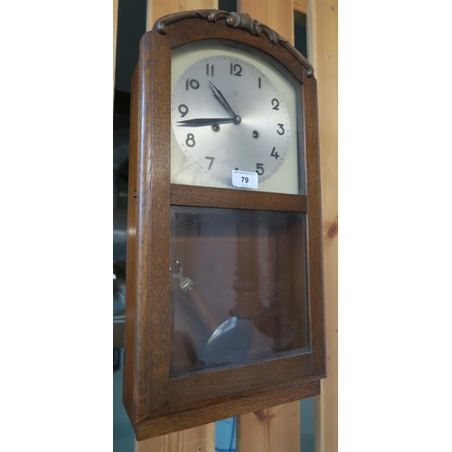 79 - A 20th century oak cased wall clock