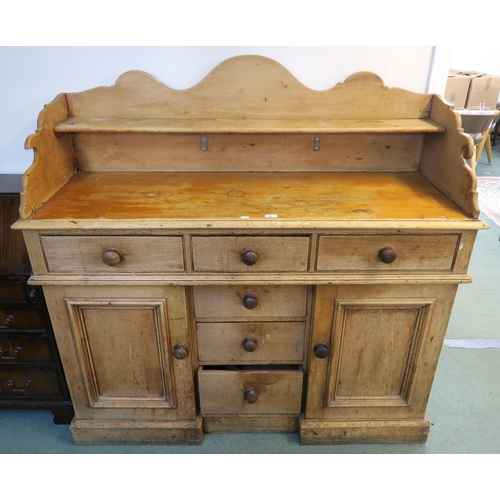 82 - A late Victorian pine sideboard with galleried top above three drawers, above three drawers flanked ... 