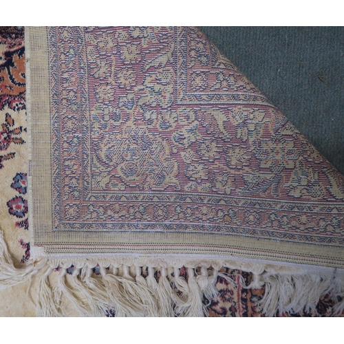 92 - A beige ground kashan rug with pink central medallion and matching borders, 204cm long x 128cm wide