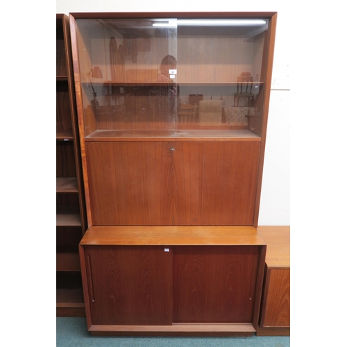 96 - A mid 20th century teak Danish drinks cabinet with glass sliding doors above fall front compartment ... 