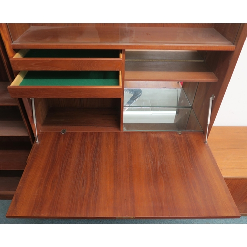 96 - A mid 20th century teak Danish drinks cabinet with glass sliding doors above fall front compartment ... 