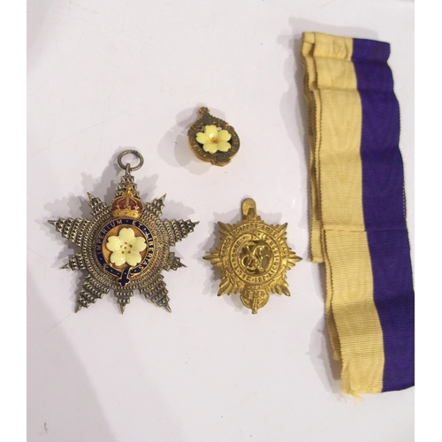 507 - A Primrose League medal and lapel button together with a Royal Army Service Corps badge