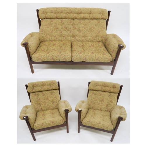 123 - A mid 20th century teak framed Guy Rogers Santa Fe three piece suite with floral buttoned upholstery... 