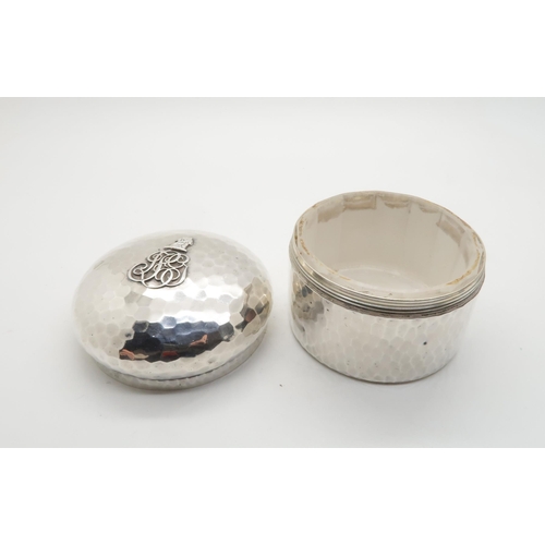 351 - A French silver toilet box/ powder box, the body with a hammered finish, with applied crest to the l... 