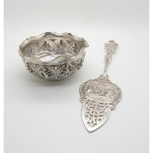 353 - A German silver cake server, the server with pierced floral decoration, the body with repousse decor... 