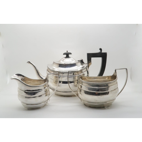 367 - A matched three piece silver tea service, the bodies with banding and reeded rims, by S.Blanckensee ... 