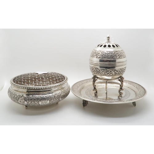 373 - An Iranian silver censer, with chased floral decoration, the rim beaded, marked to base, and a Persi... 