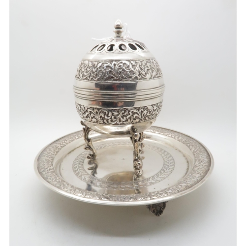 373 - An Iranian silver censer, with chased floral decoration, the rim beaded, marked to base, and a Persi... 