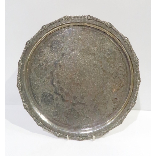 374 - An Iranian silver circular tray, with engraved arabic floral motifs, with applied floral rim, hallma... 