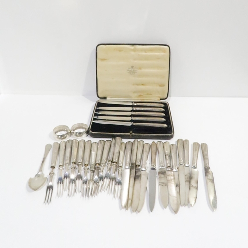 384 - A collection of silver including silver handled entrée knives and forks by William Hutton & Sons... 