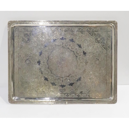 385 - An Iranian silver rectangular serving tray, with chased decoration of arabic floral motifs, stamped ... 