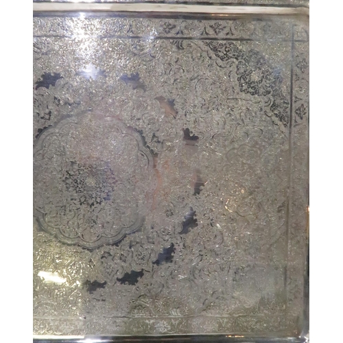 385 - An Iranian silver rectangular serving tray, with chased decoration of arabic floral motifs, stamped ... 