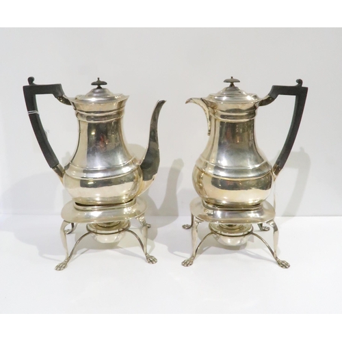 396 - An Edwardian silver tea and hot water set, comprising teapot, hot water pot, with silver warmers sup... 