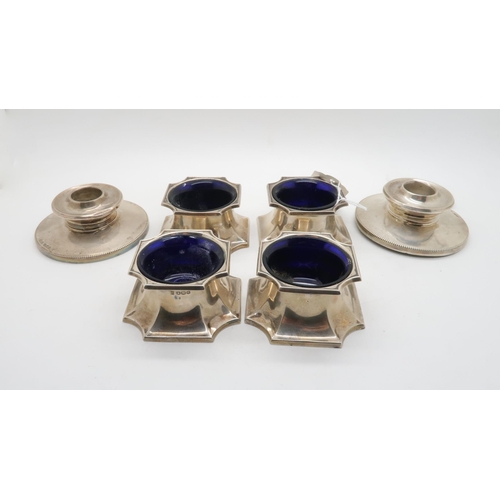 398 - A set of four George V silver salts, of canted form, with blue glass liners, by Cooper Brothers &... 