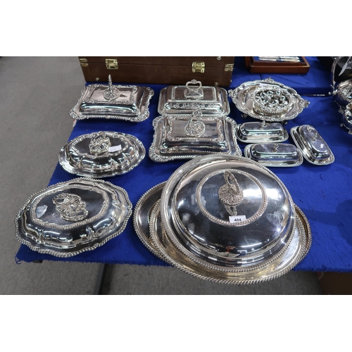 404 - A collection of silver plated entrée dishes, comprising three rectangular examples, a large circular... 