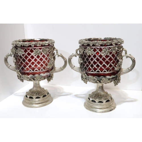 262 - A pair of ruby flashed and cut glass two handled centrepieces in metal mounts and a similar gla... 