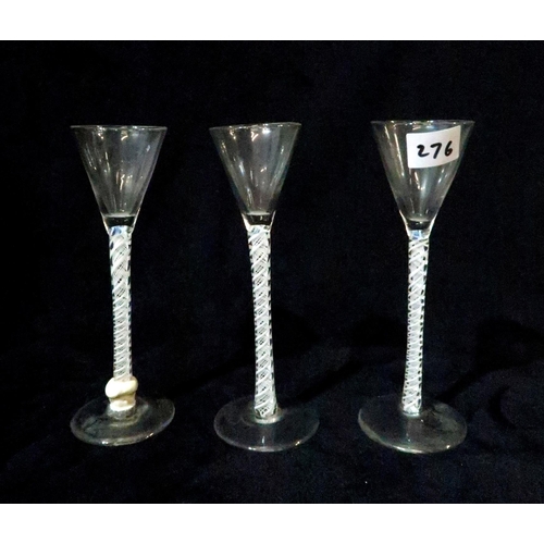 276 - Three ribbon twist glasses and four other antique glasses