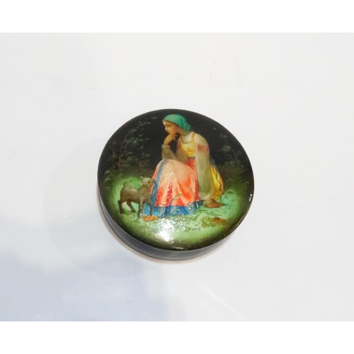 281 - A circular Russian lacquer patch box depicting a girl and lamb, a brass vesta decorated with pandas ... 