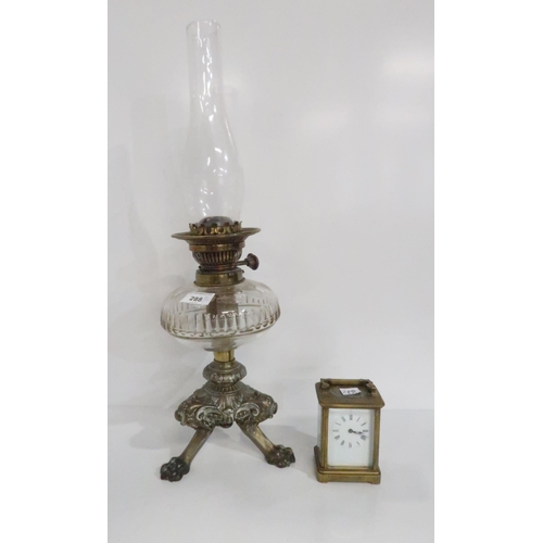 288 - A brass cased carriage clock and an oil lamp with Trademark in Lux Way to buttons