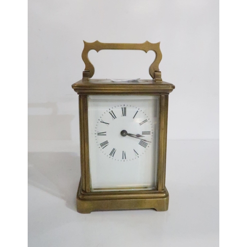 288 - A brass cased carriage clock and an oil lamp with Trademark in Lux Way to buttons