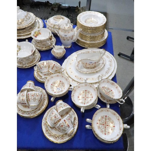 309 - A Tuscan Richelieu pattern dinner service comprising plates, bowls, coffee pot, platters, soup coupe... 