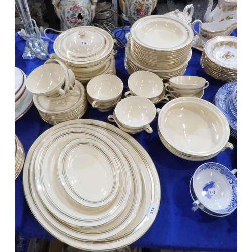 314 - A Solian ware pottery dinner service in cream with gilt and black banding