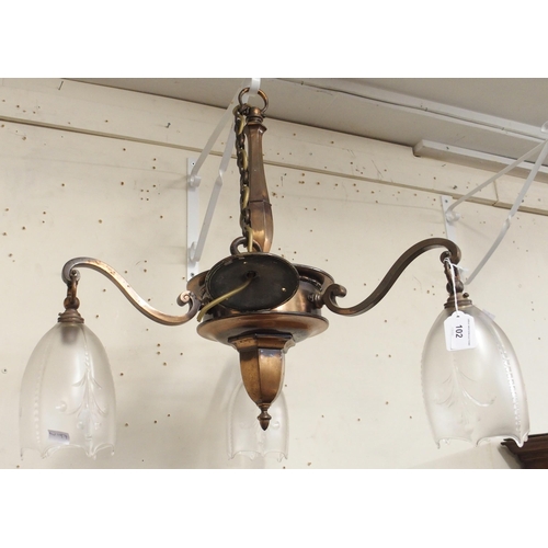 102 - A Victorian copper three branch chandelier with moulded glass shades