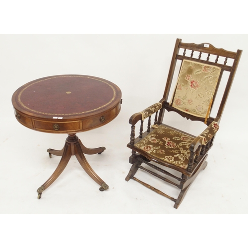 121 - A 20th century mahogany framed American rocking chair, mahogany drum table, two travel trunks (one c... 