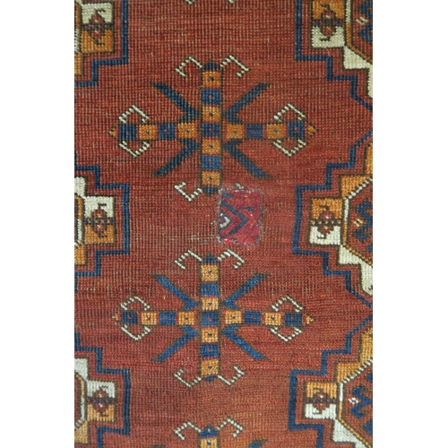 40 - A red ground eastern tribal wall hanging with all over design, 96cm high x 152cm wide