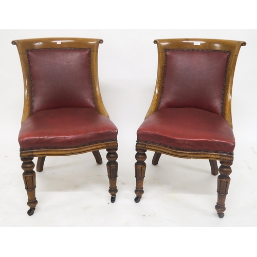 61 - A pair Victorian oak framed and rexine upholstered chairs (2)