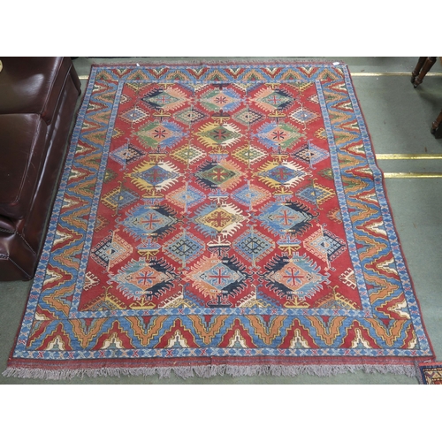 63 - A red ground Kazak rug with all over design and multicoloured borders, 210cm long x 188cm wide