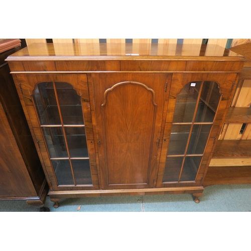 80 - A 20th century mahogany glazed bookcase with central panel door flanked by glazed doors on cabriole ... 