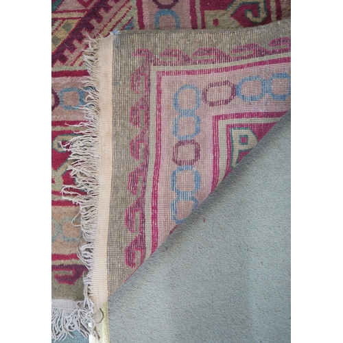 91 - A green ground Kilim rug with three geometric medallions and multicoloured borders, 271cm long x 187... 