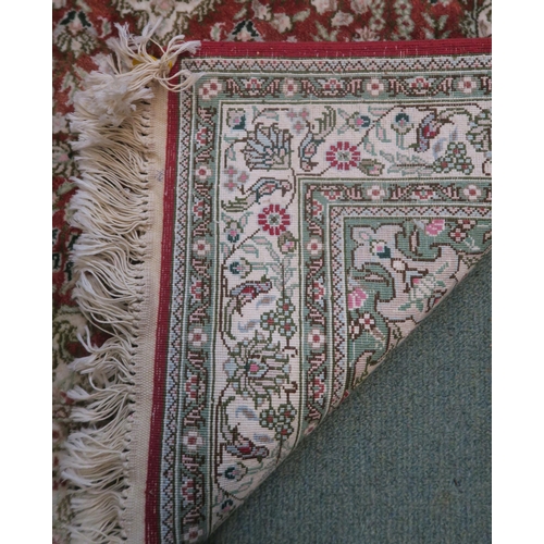 95 - A modern rust ground eastern style rug and an oval oriental style rug (2)