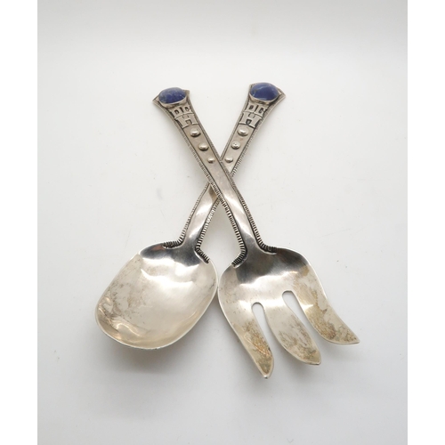 386A - A pair of sterling salad servers, the terminals inset with lapis cabochons, with applied initials an... 