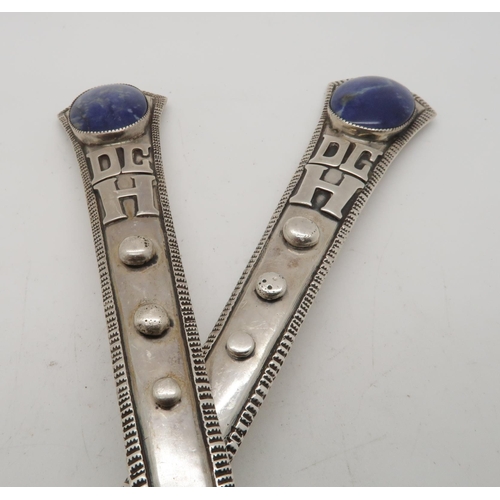 386A - A pair of sterling salad servers, the terminals inset with lapis cabochons, with applied initials an... 