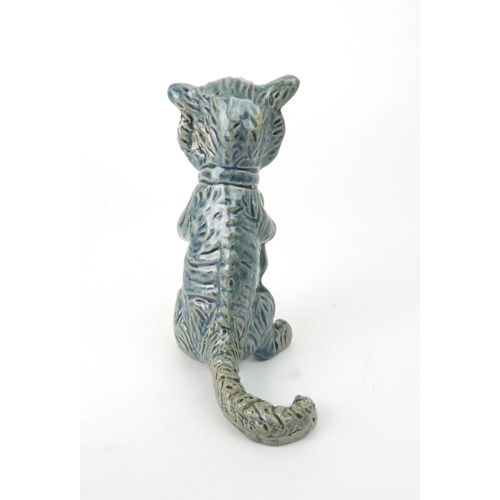 159 - A DUNMORE POTTERY MODEL OF A CATholding kittens, 11.5cm high