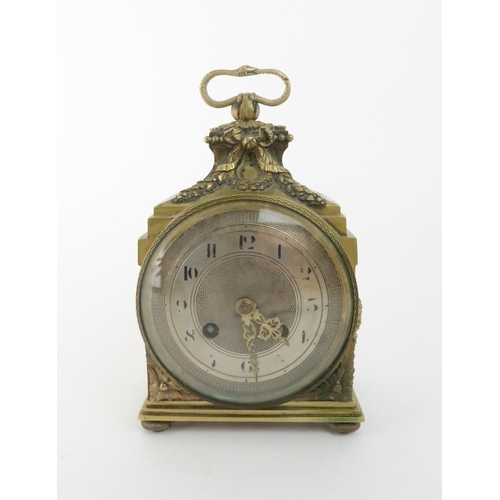 170 - A FRENCH BRASS MANTLE CLOCK with silvered dial, chiming on the quarter, with laurel wreath deco... 