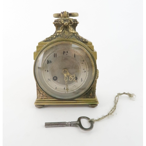 170 - A FRENCH BRASS MANTLE CLOCK with silvered dial, chiming on the quarter, with laurel wreath deco... 