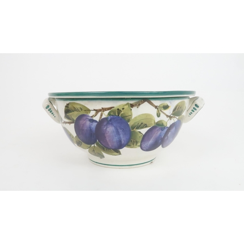 191 - A WEMYSS FRUIT DRAINER AND BOWLpainted with the plum pattern, the bowl with two ring handles and mar... 