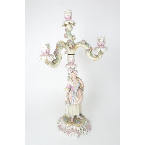 194 - A PAIR OF MEISSEN STYLE CANDELABRASeach with a figure below floral encrusted candle arms, 52cm high... 