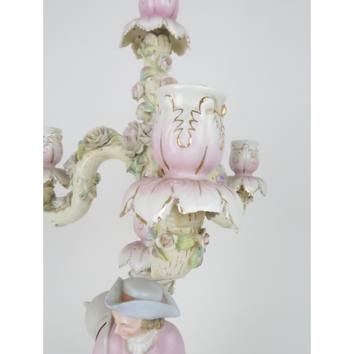 194 - A PAIR OF MEISSEN STYLE CANDELABRASeach with a figure below floral encrusted candle arms, 52cm high... 