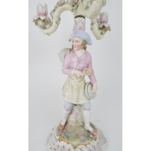 194 - A PAIR OF MEISSEN STYLE CANDELABRASeach with a figure below floral encrusted candle arms, 52cm high... 