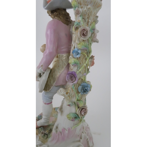 194 - A PAIR OF MEISSEN STYLE CANDELABRASeach with a figure below floral encrusted candle arms, 52cm high... 