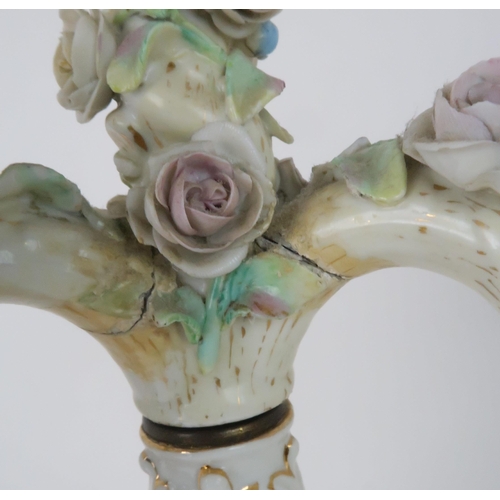 194 - A PAIR OF MEISSEN STYLE CANDELABRASeach with a figure below floral encrusted candle arms, 52cm high... 