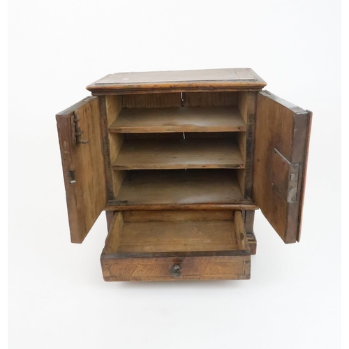 210 - AN APPRENTICE PIECE CHESTthe two door opening to reveal shelves above a drawer, 26cm high... 